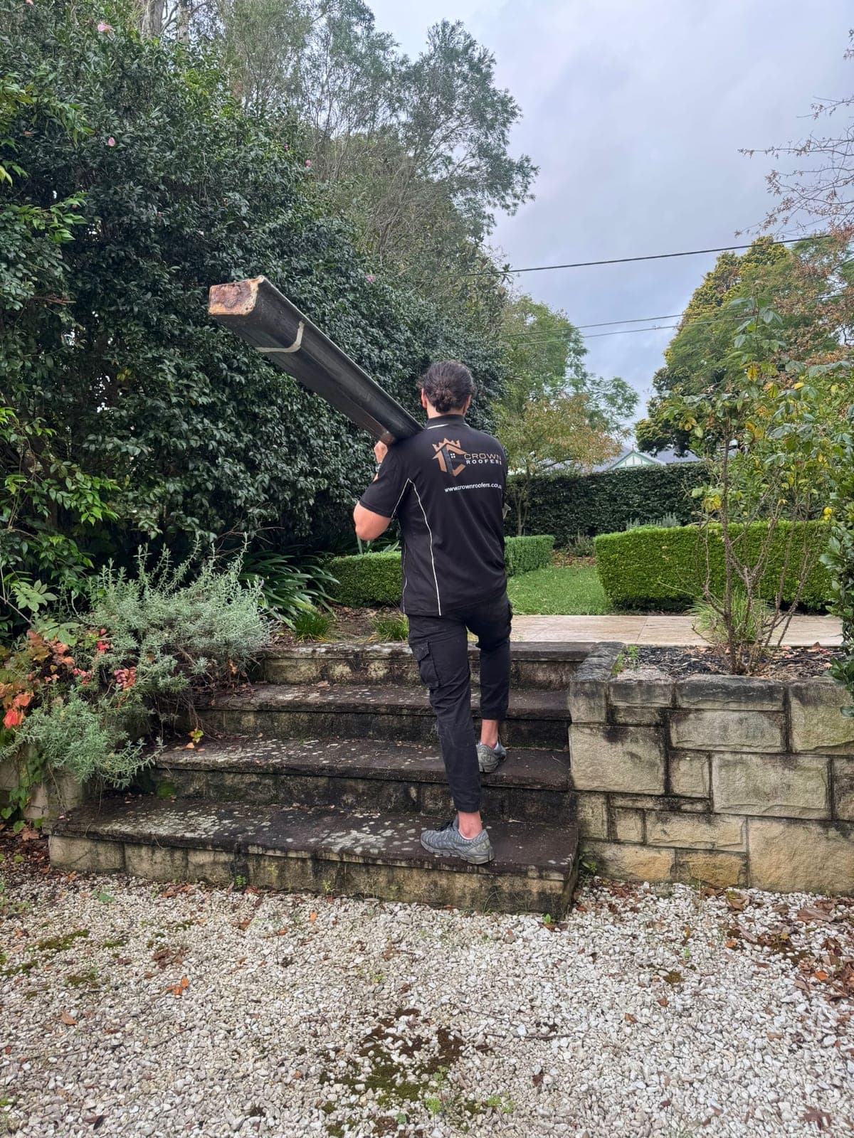 Crown Roofers fitting a new downpipe on a Sydney property