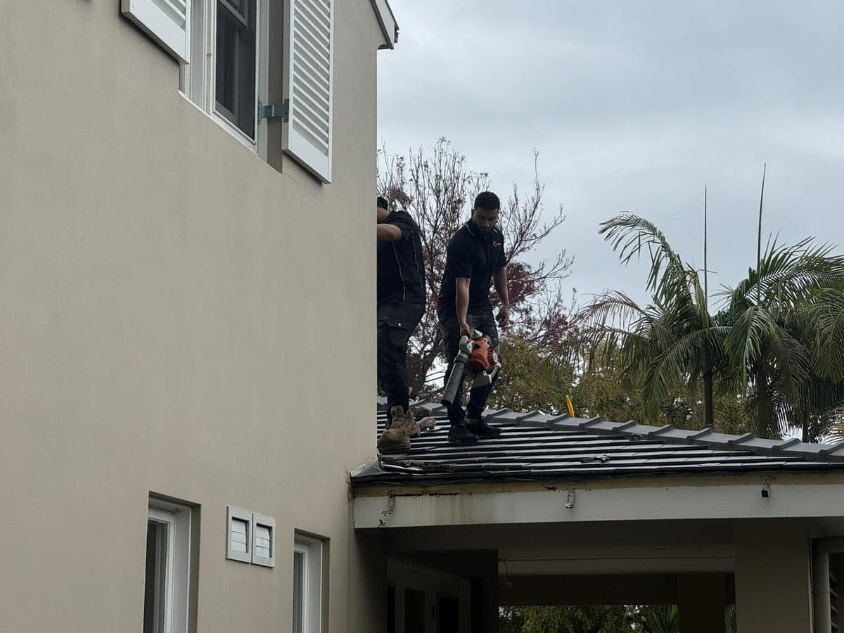 Crown Roofers crew clearing a tile roof and gutters on a Sydney home