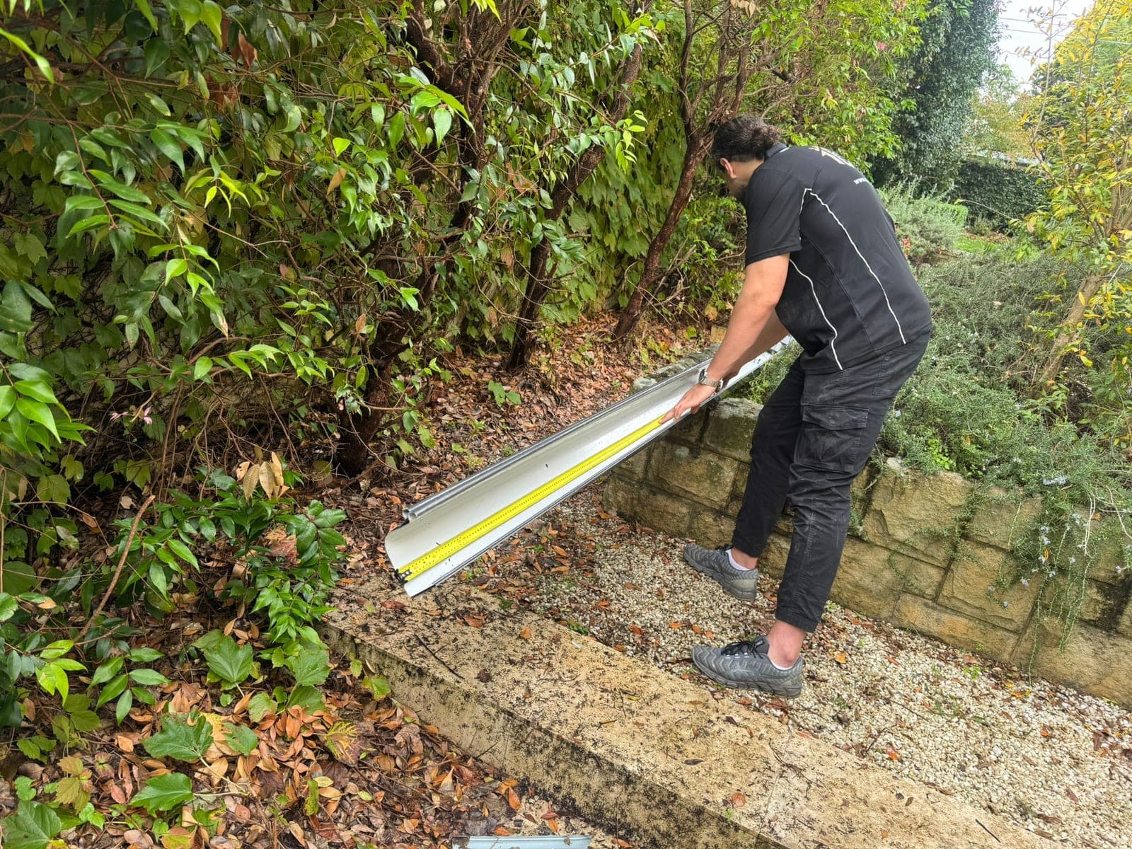 Crown Roofers installing a new Colorbond gutter on a Sydney home