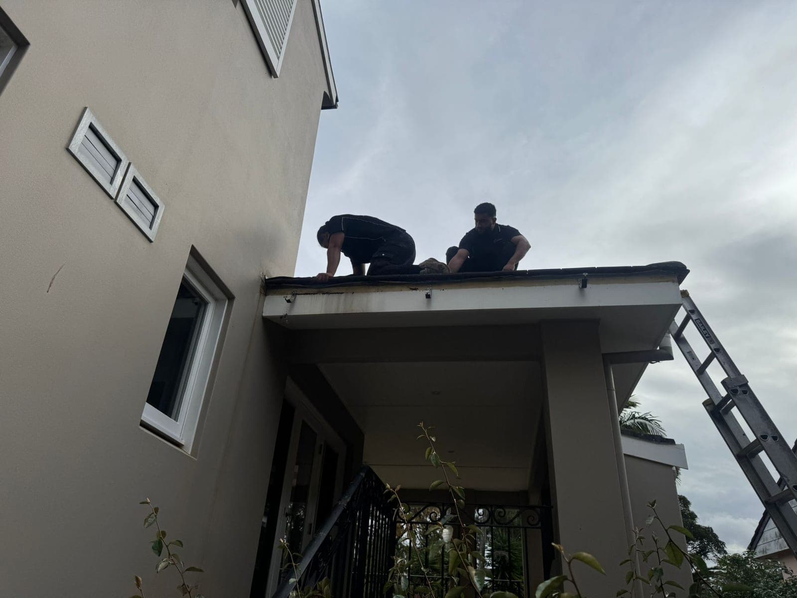 Crown Roofers licensed roof plumbers working on a Sydney roofline