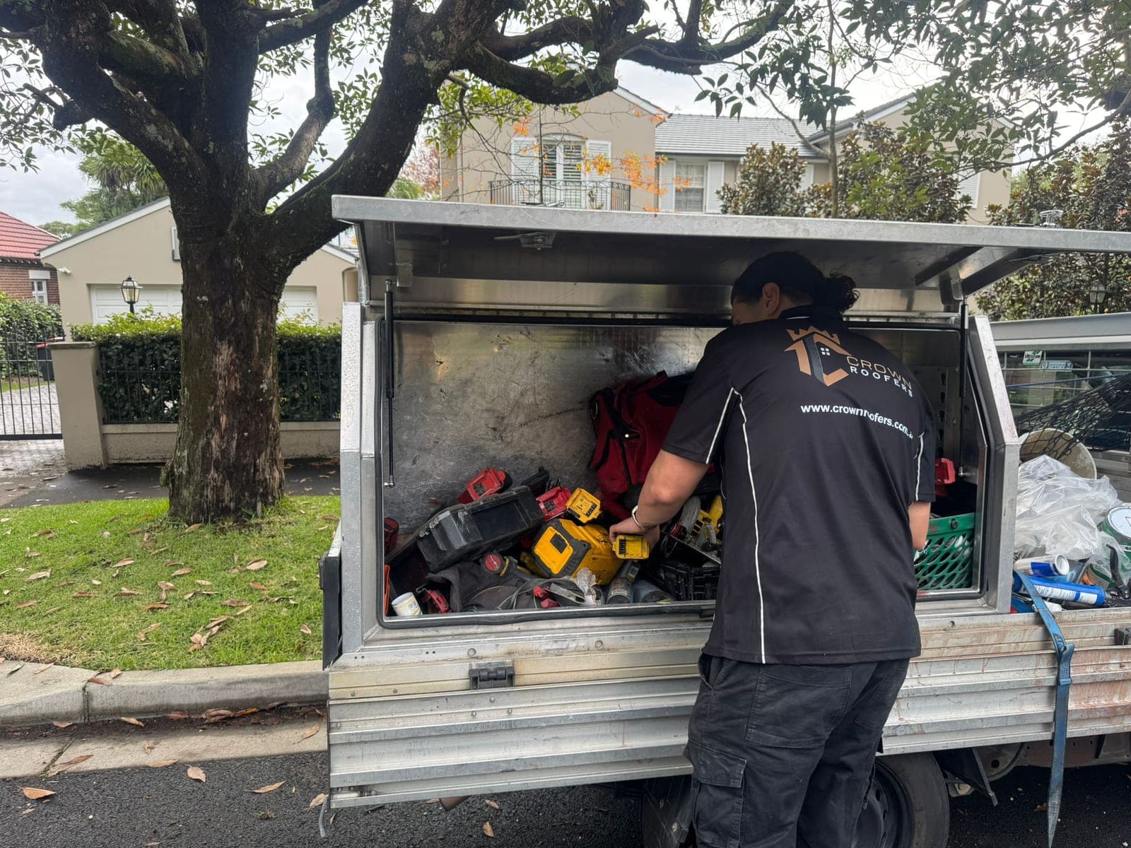 Crown Roofers tradesperson at the fully-equipped work ute on a Sydney job