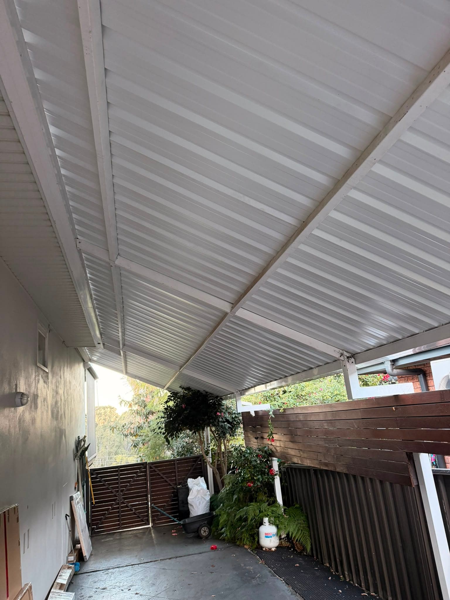 Colorbond and polycarbonate re-sheet Crown Roofers Emu Heights — walkway roof finished in white Colorbond