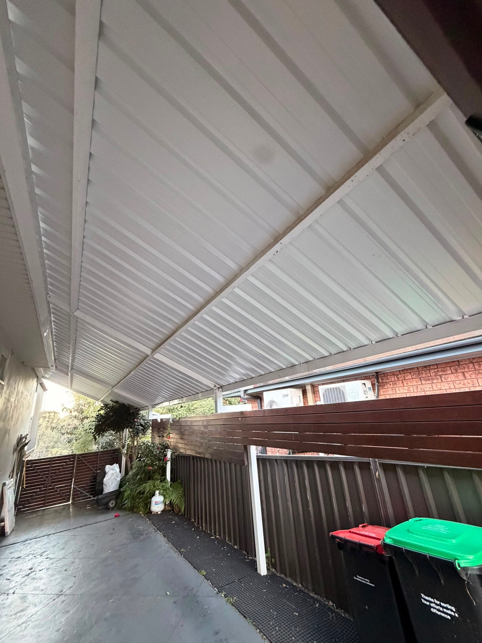 Colorbond and polycarbonate re-sheet Crown Roofers Emu Heights — back deck sheeting and wall flashing detail
