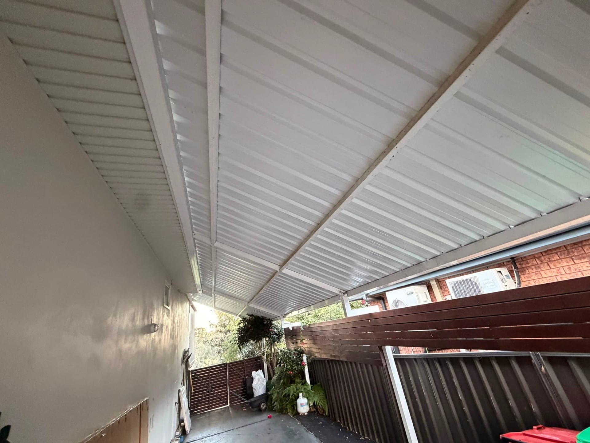 Colorbond and polycarbonate re-sheet Crown Roofers Emu Heights — completed back deck roof over the outdoor living area