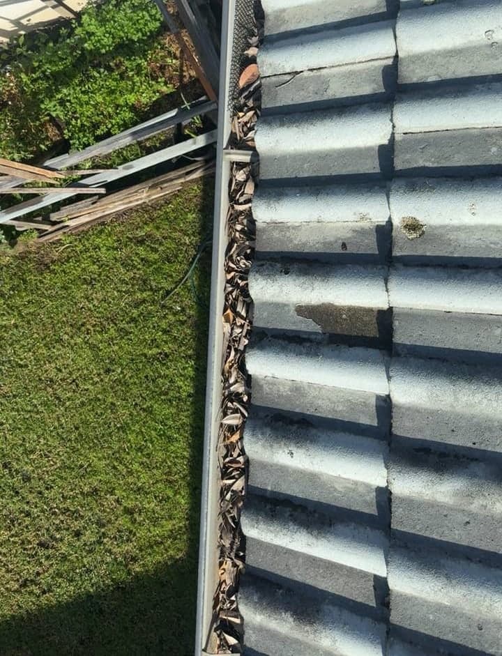 Residential gutter cleaning — Crown Roofers project Emerton Western Sydney — blocked gutter run with accumulated organic matter