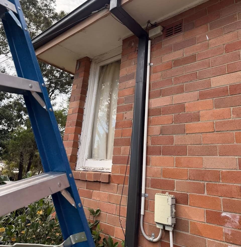 New Colorbond gutter and downpipe replacement Crown Roofers Sydney residential — photo 1 v2