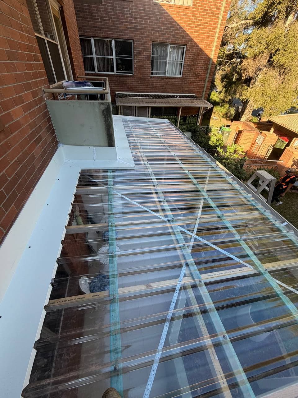 Completed polycarbonate pergola roof installed by Crown Roofers in Riverwood, Sydney