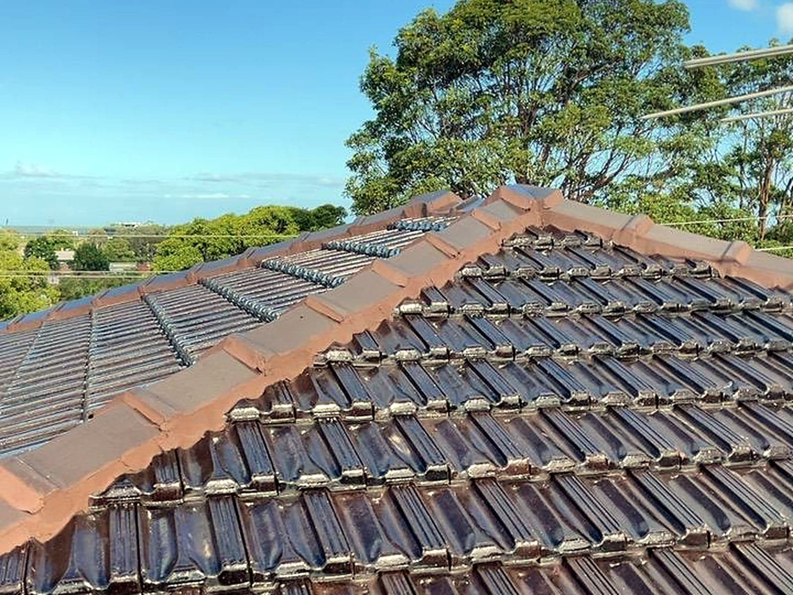 Freshly repointed ridge capping on a glazed tile roof, Sydney