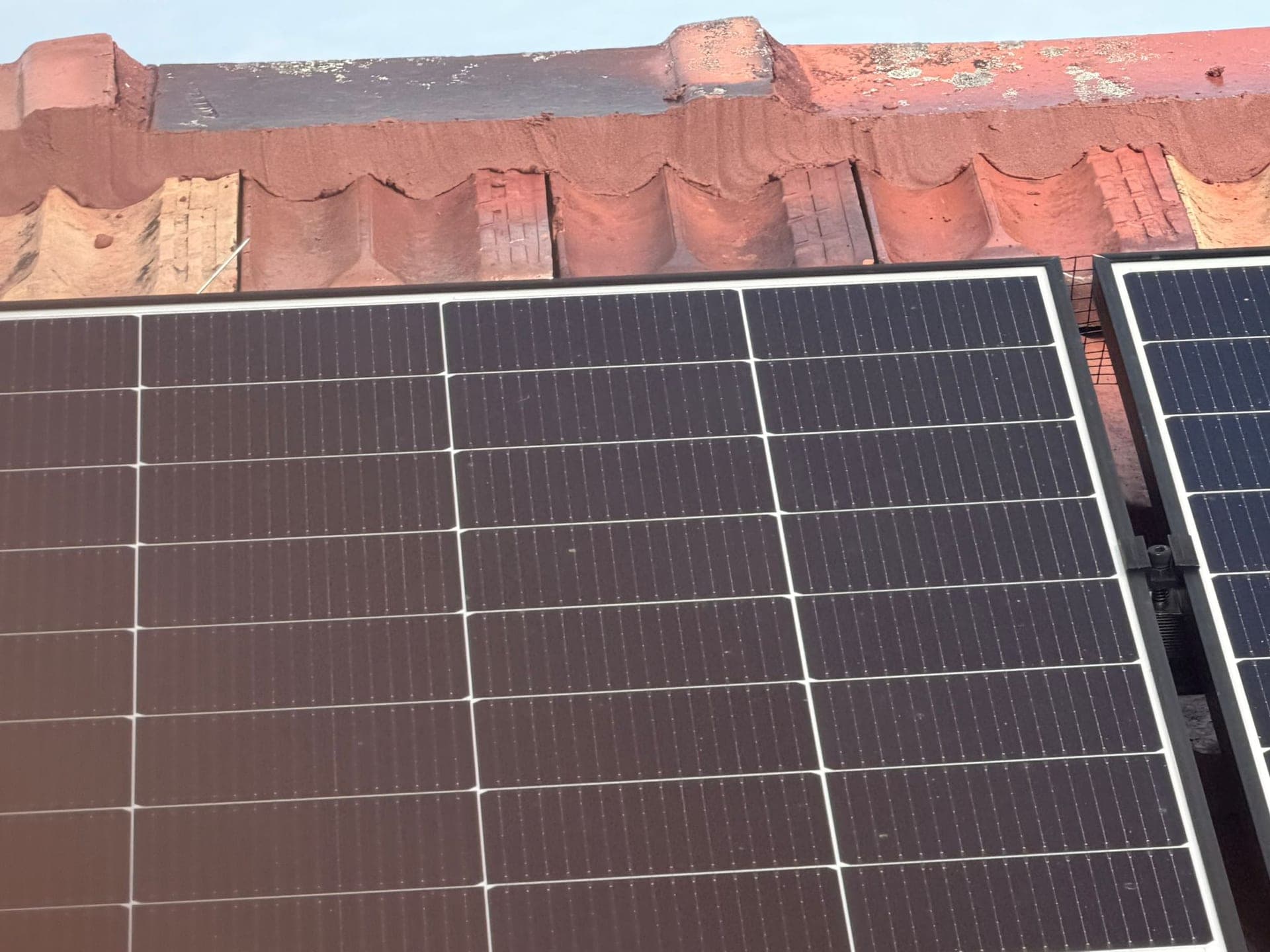 Aged terracotta tile roof with solar panels — Crown Roofers tile restoration project Epping North Shore Sydney — photo 4