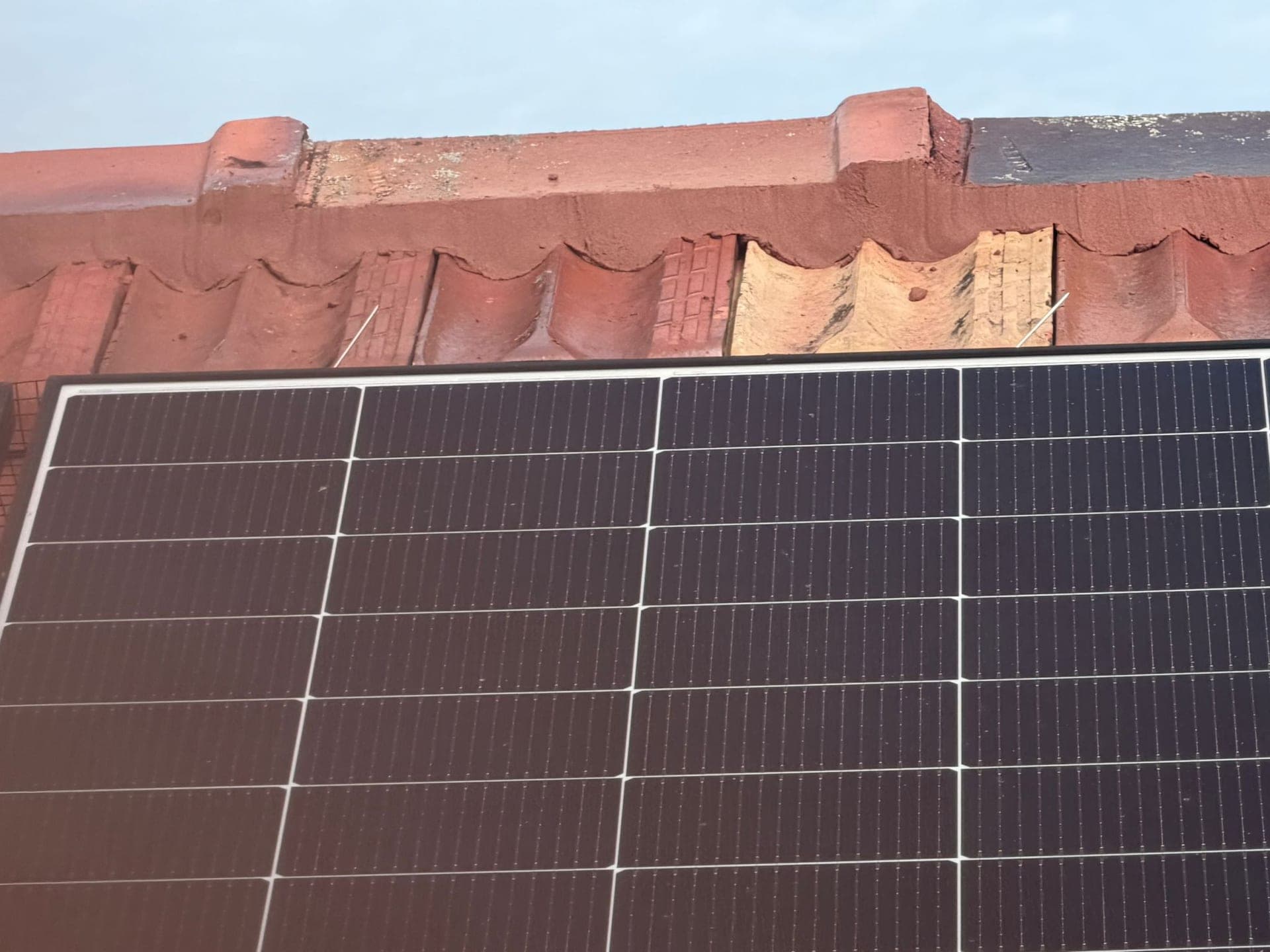 Aged terracotta tile roof with solar panels — Crown Roofers tile restoration project Epping North Shore Sydney — photo 5