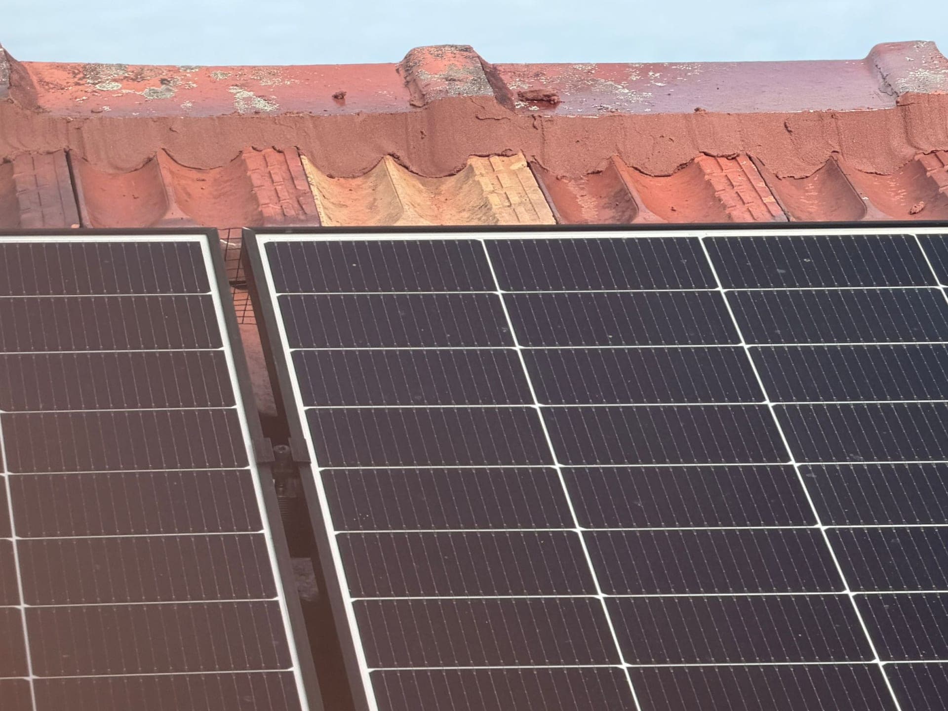 Aged terracotta tile roof with solar panels — Crown Roofers tile restoration project Epping North Shore Sydney — photo 6