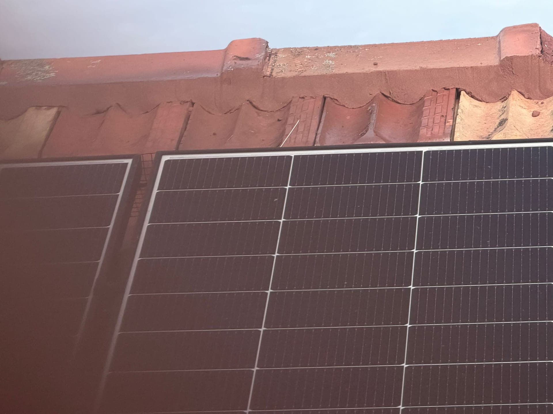 Aged terracotta tile roof with solar panels — Crown Roofers tile restoration project Epping North Shore Sydney — photo 7