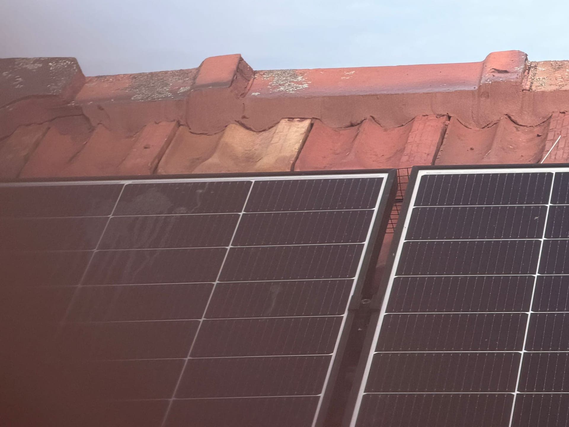 Aged terracotta tile roof with solar panels — Crown Roofers tile restoration project Epping North Shore Sydney — photo 8