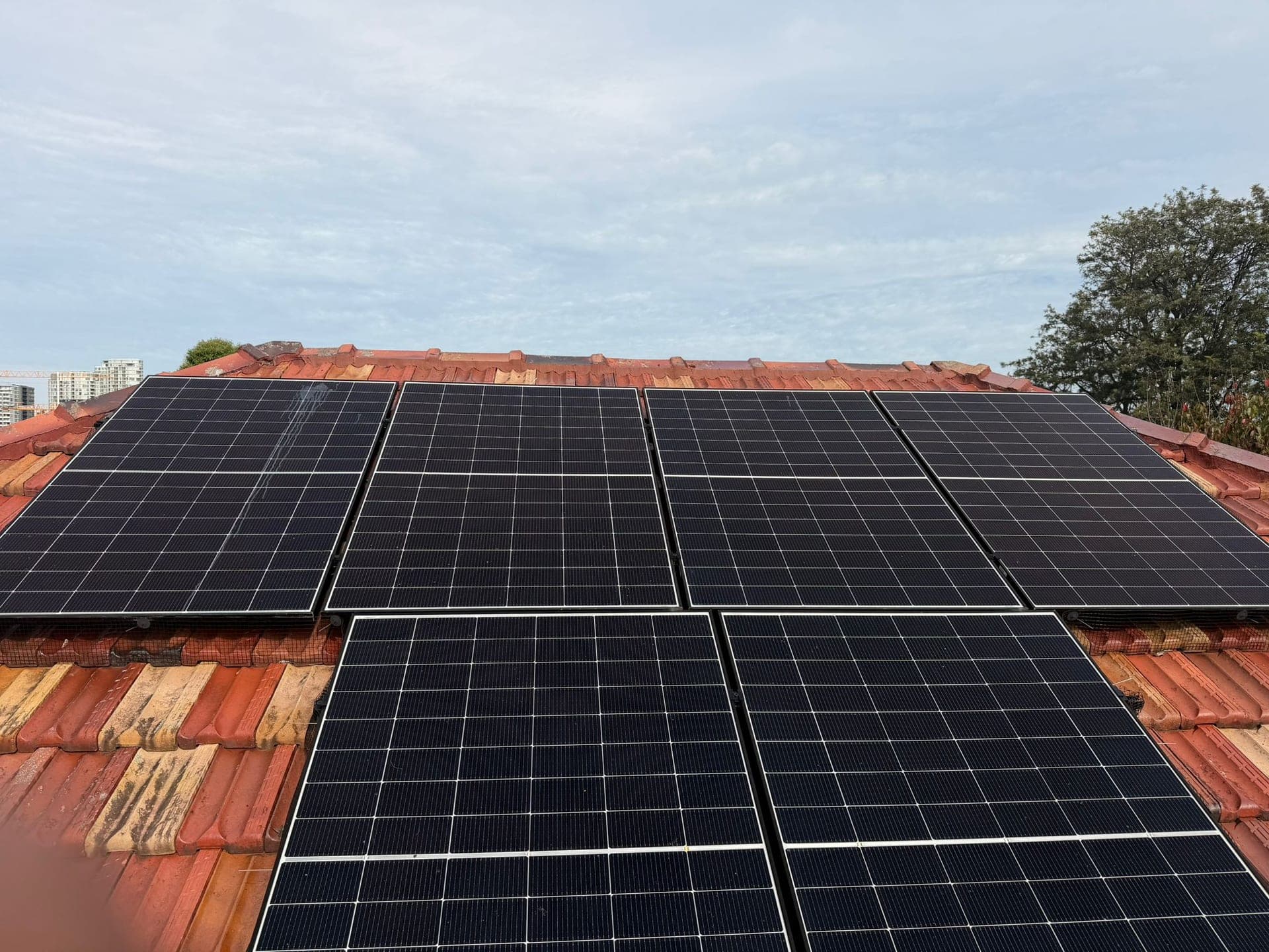 Aged terracotta tile roof with solar panels — Crown Roofers tile restoration project Epping North Shore Sydney — photo 10