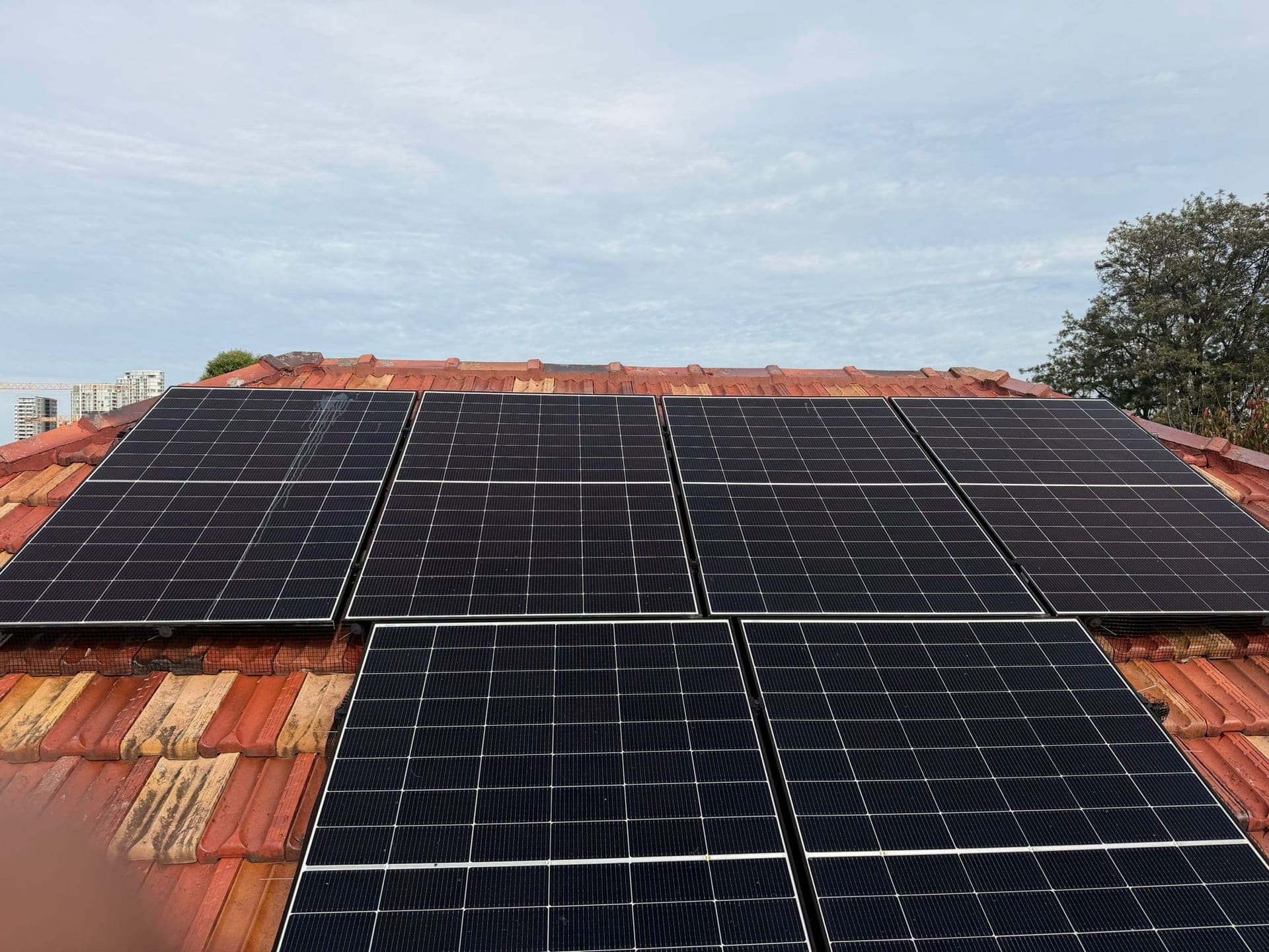 Aged terracotta tile roof with solar panels — Crown Roofers tile restoration project Epping North Shore Sydney — photo 11