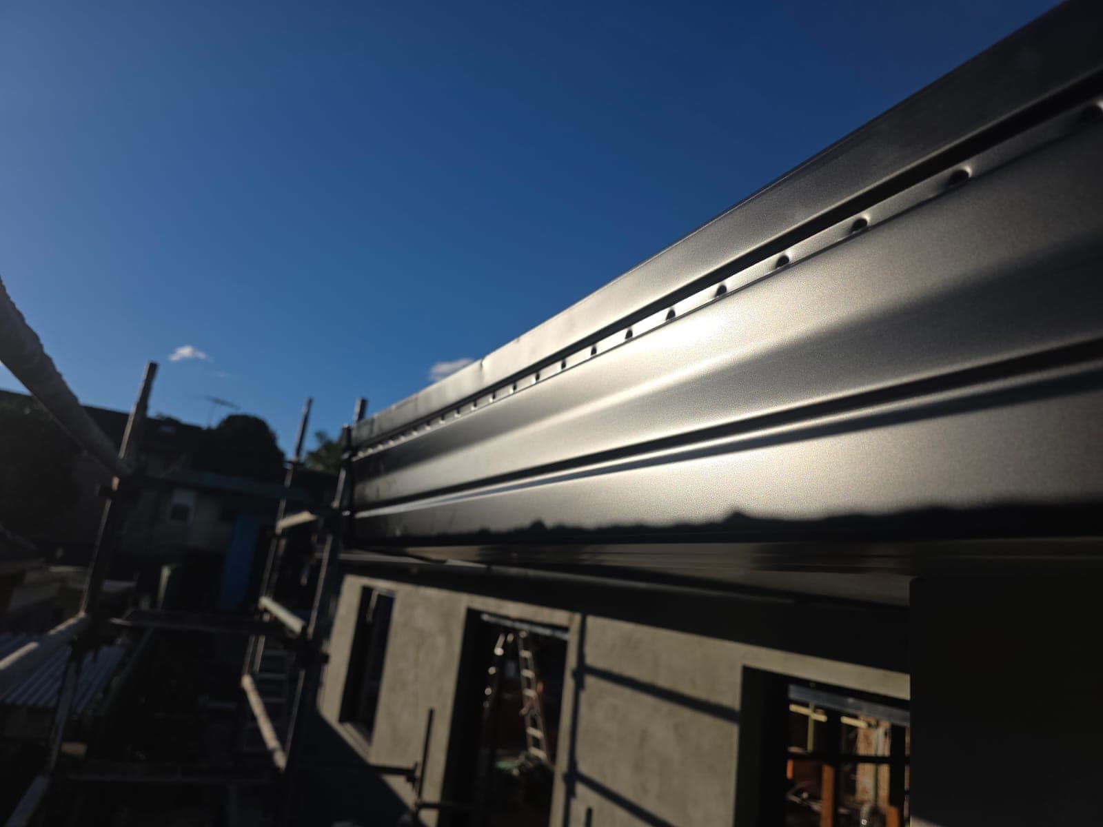 Tile roof restoration and new guttering Crown Roofers Kingsgrove — new gutter line running clean to the downpipe