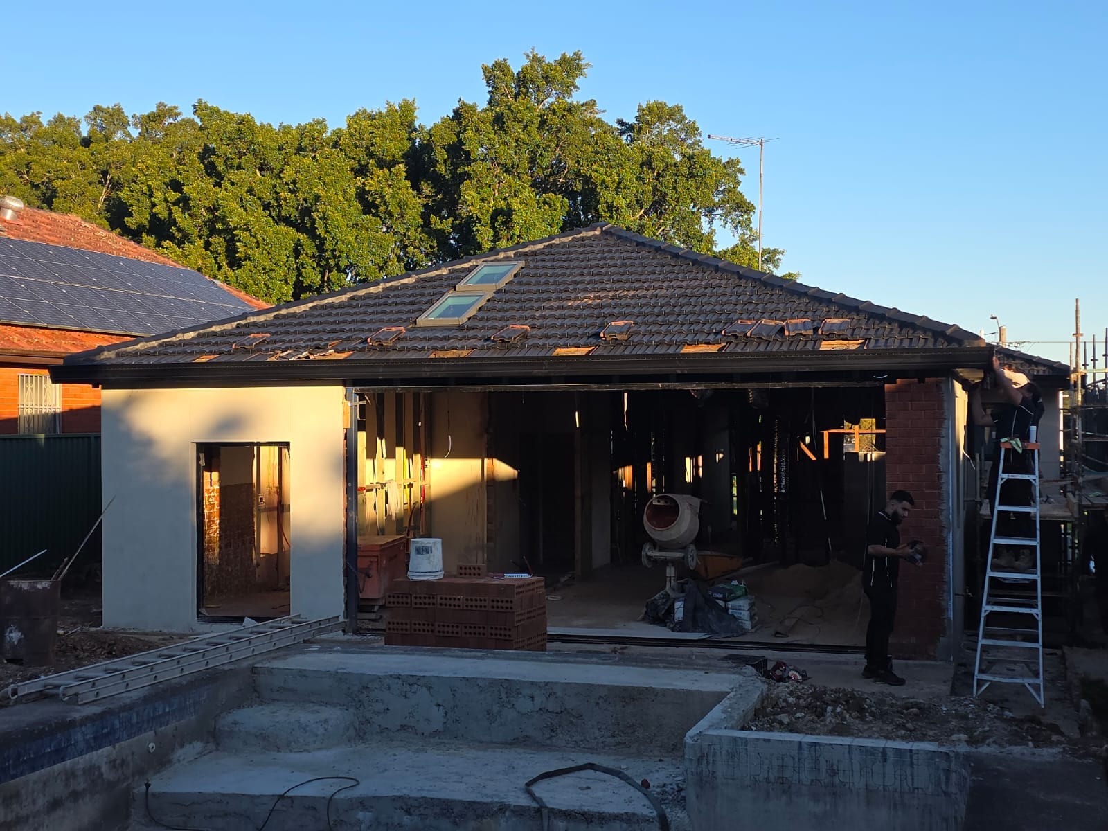 Tile roof restoration and new guttering Crown Roofers Kingsgrove — recoated tile roof with rebedded and repointed ridge capping