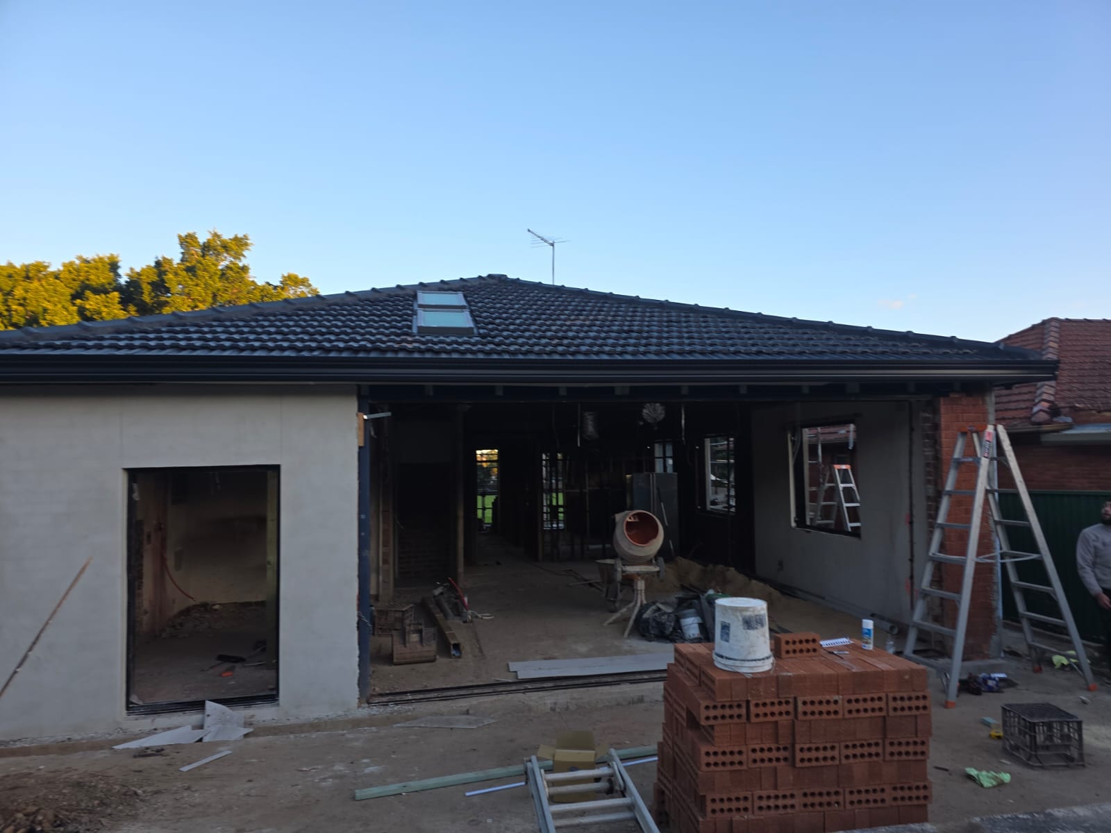 Tile roof restoration and new guttering Crown Roofers Kingsgrove — new charcoal Colorbond guttering and fascia along the eave